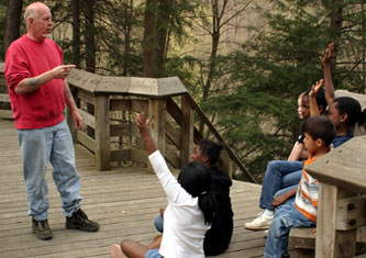 A teacher working lecturing outside to students
