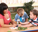 Teacher doing science exploration with two students