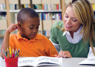 A teacher offering homework help to a student