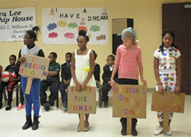 students acting as protestors in Black history month performance