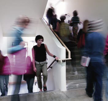 Students walking to class in a stairwell.