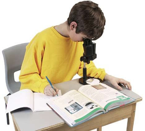 Photograph of a boy looking in a microscope.
