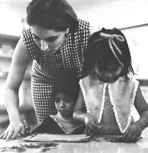 Photo of a teachers and two girls.