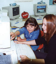 Girl working on computer with lady