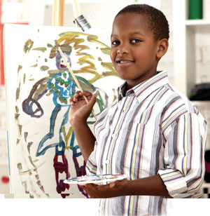 A photo of a boy painting.
