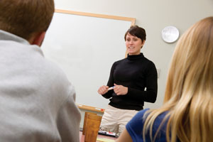 A teacher talks to staff during a professional development session.