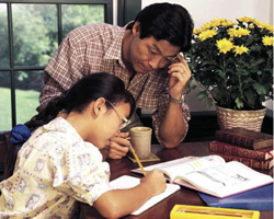 photo of a father and daughter studying
