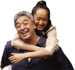photo of a father giving daughter a piggyback ride
