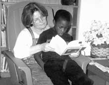 Rapoport Academy director Nancy Grayson takes time out to read with one of her students.